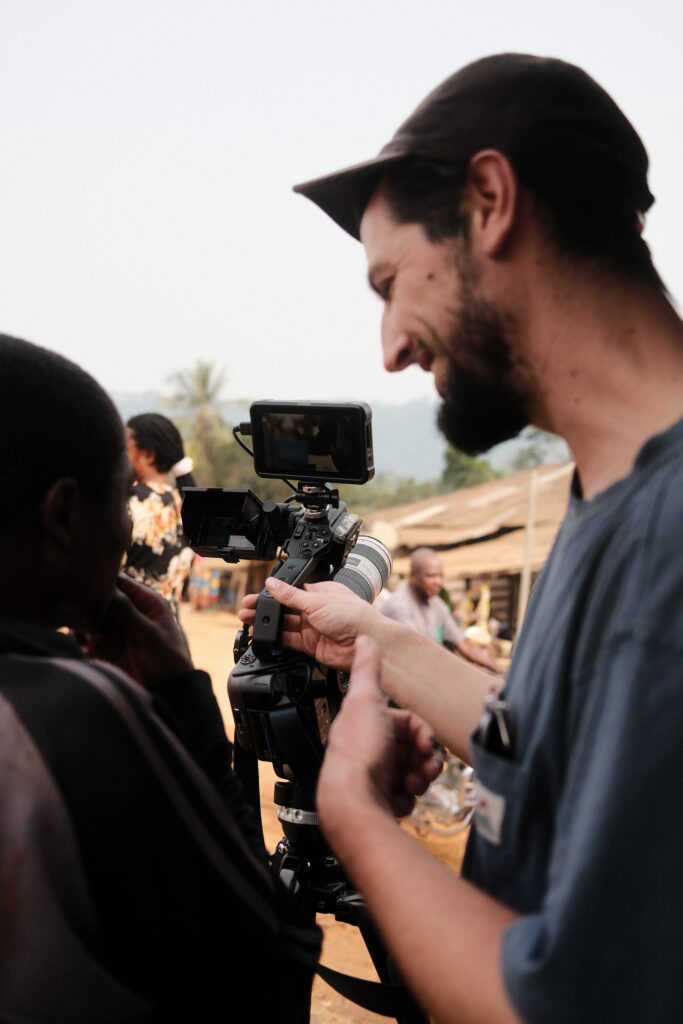 Leo showing the community what he's filming in Nigeria
